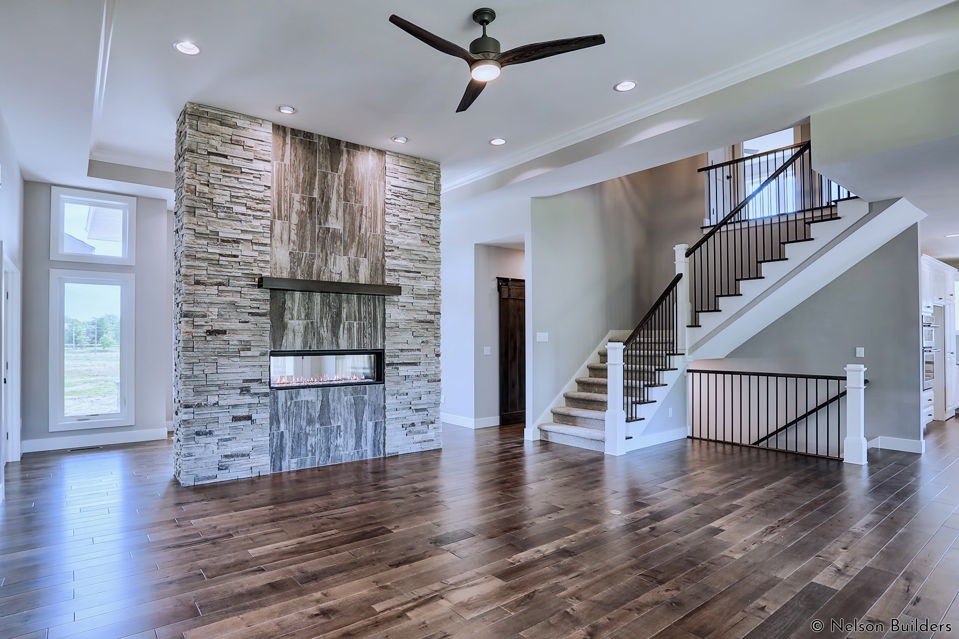 The double-sided linear fireplace is the focal point of both the entry and great room.