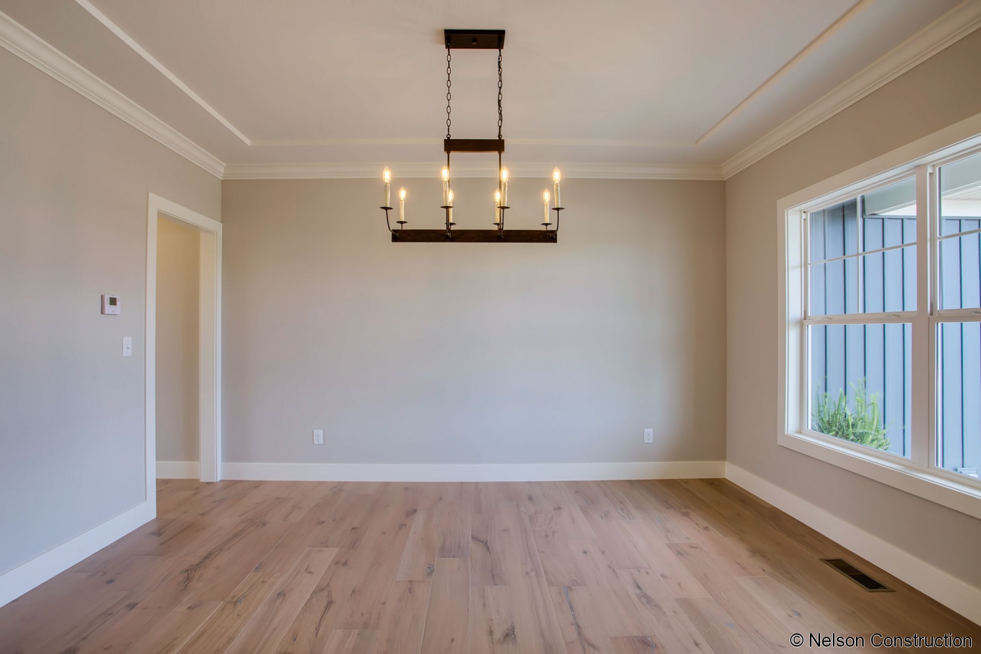 The dining room of this new Cherrydale plan features wire brushed wide plank flooring and opens to the foyer, bringing light into the space.