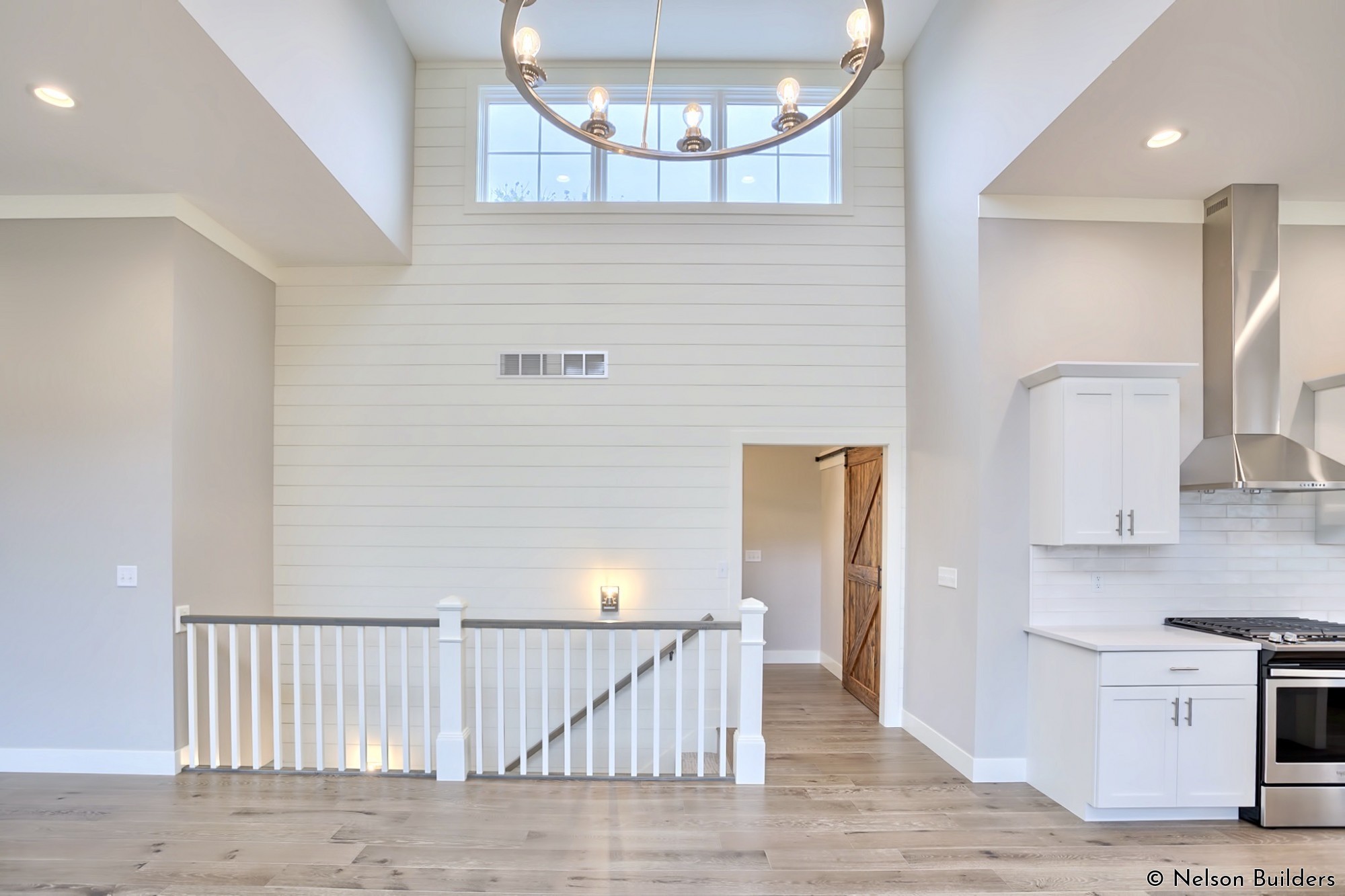 The stairway wall of the dining area serves as a focal point with over 25 feet of shiplap, all the way from the basement to the ceiling.