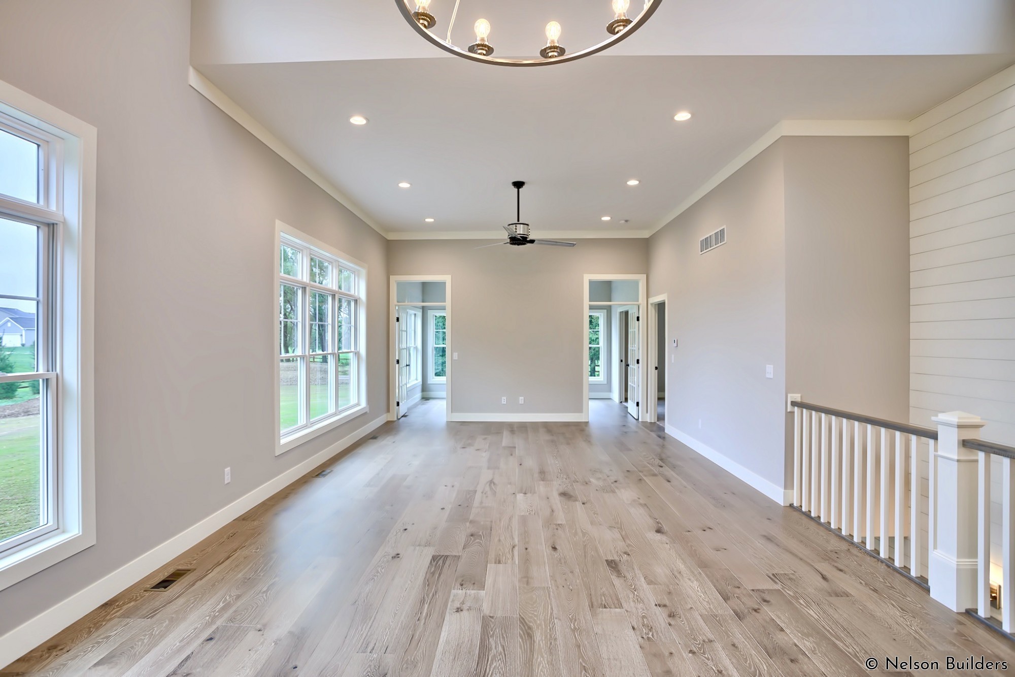 The 11-foot ceilings of the great room open to windows on the front and back over the 16-foot dining area.